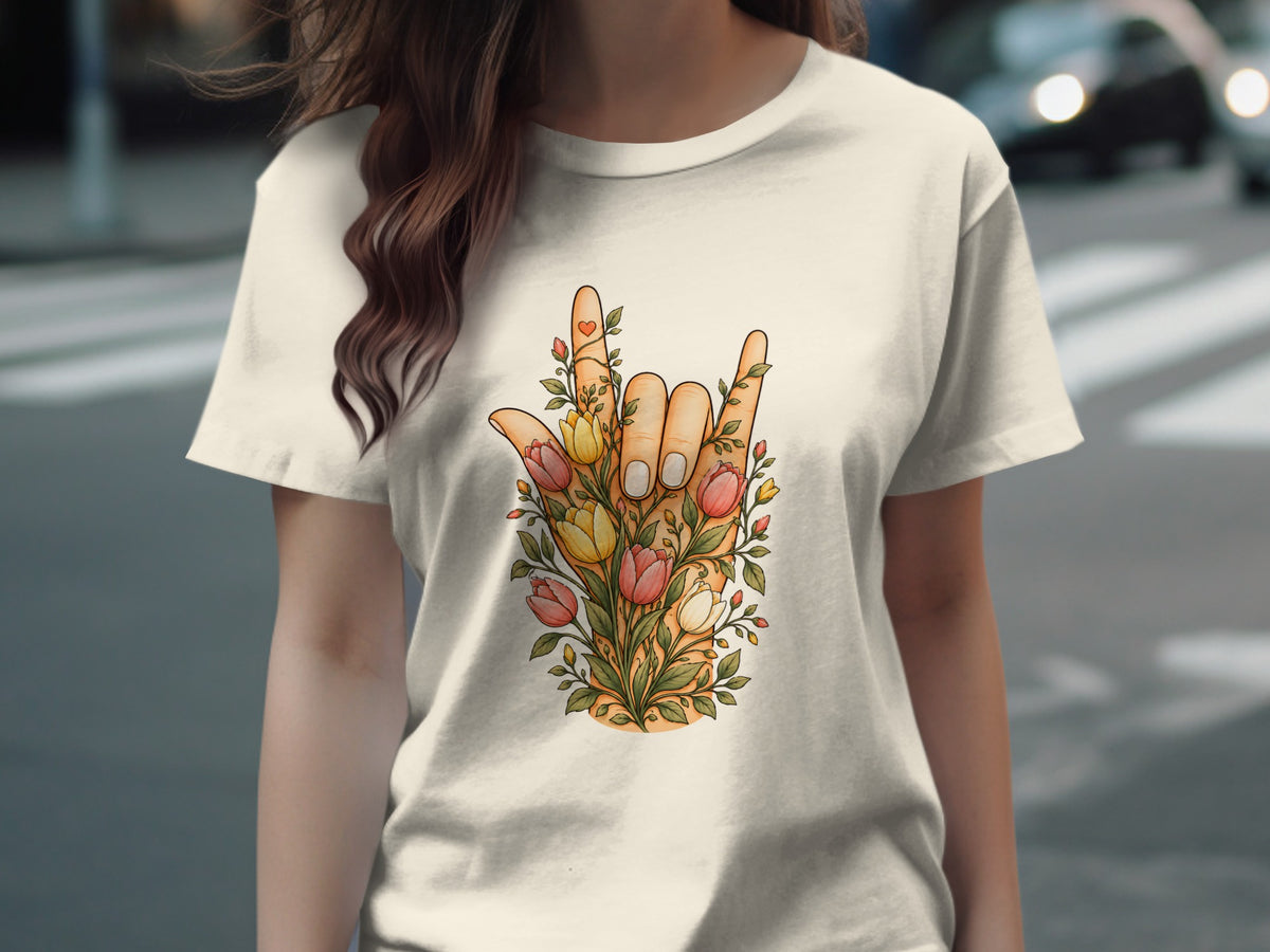 Hand forming a rock on sign with flowers and a heart.