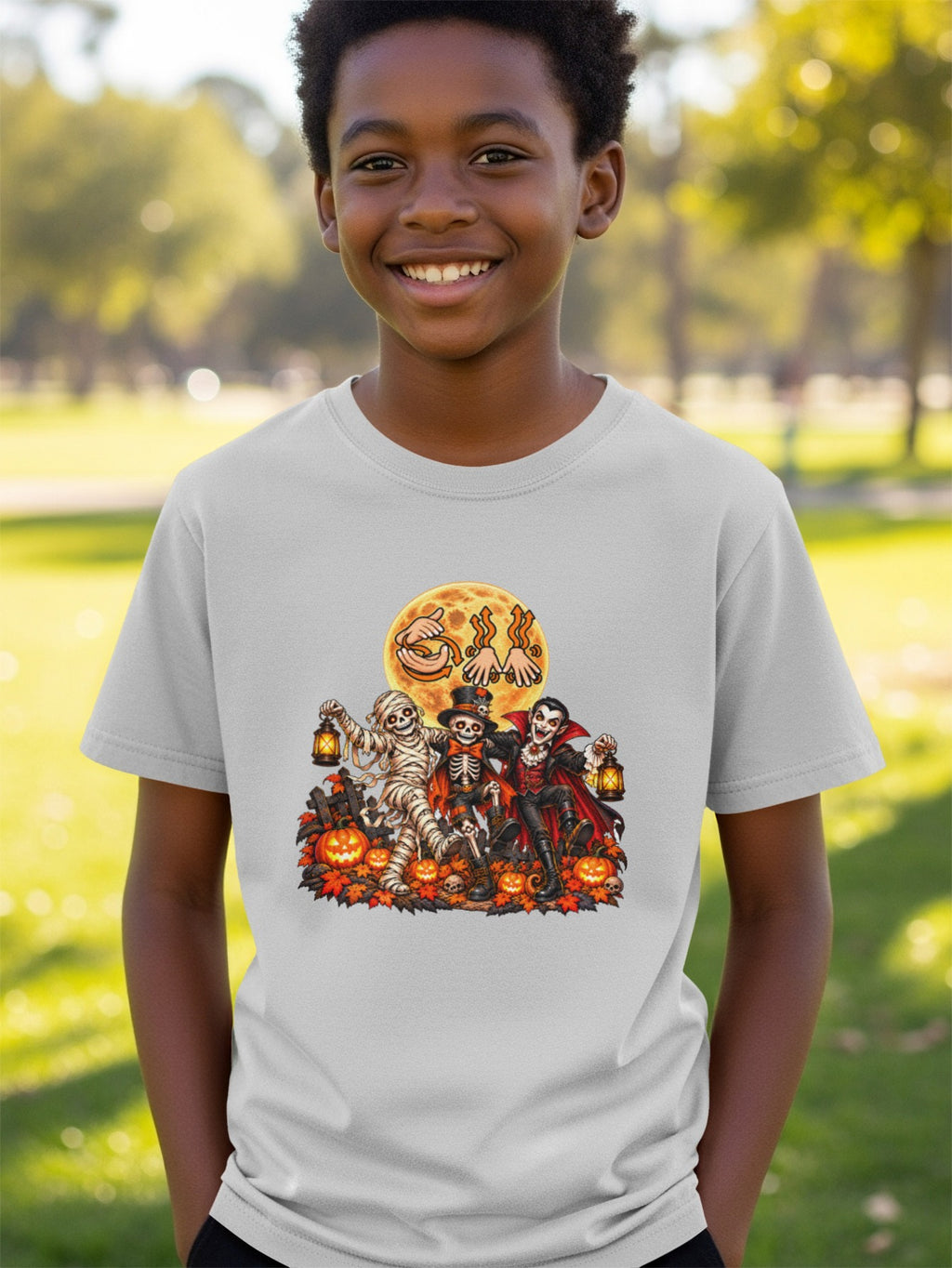 Light gray t-shirt with Halloween characters: mummy, skeleton, and vampire with pumpkins.