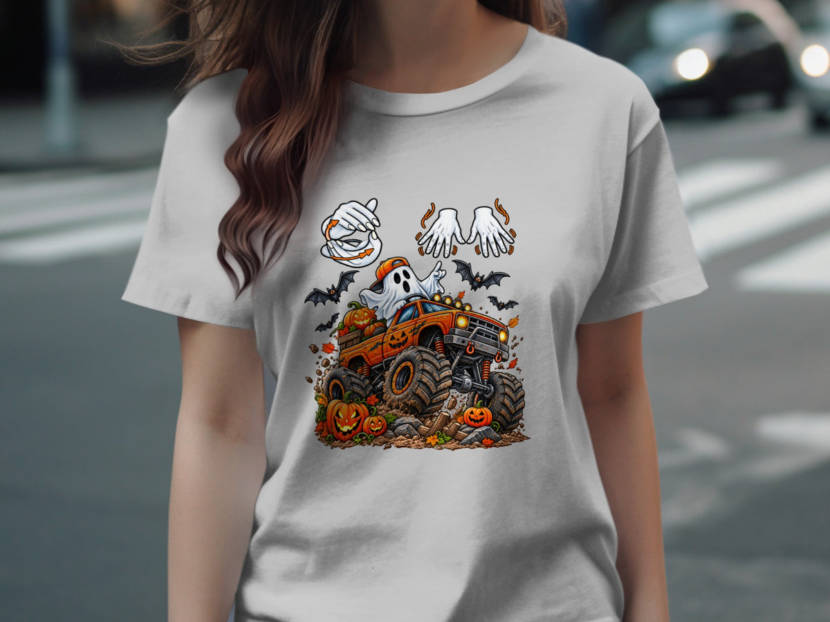 Halloween t-shirt design with a ghost driving a monster truck, pumpkins, and bats.