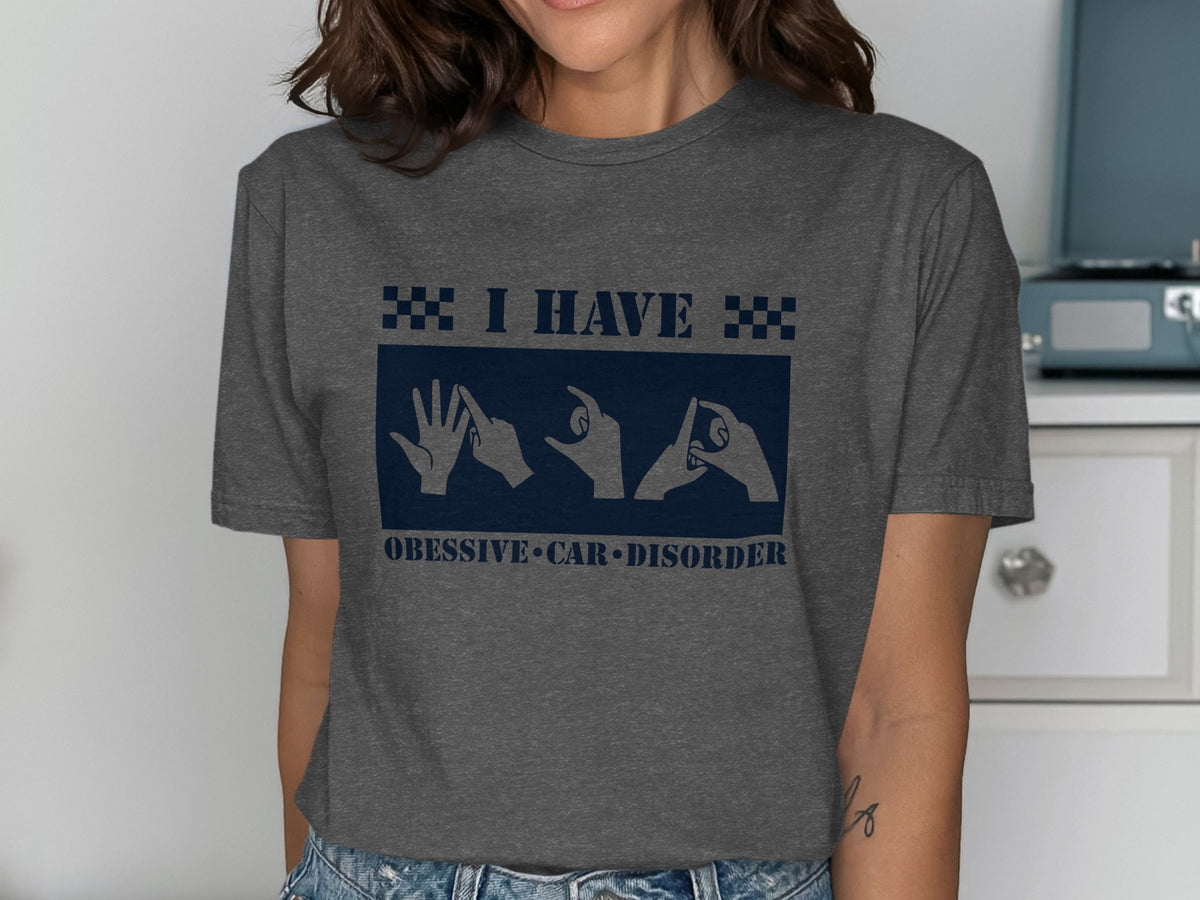 Dark grey t-shirt with "I HAVE" and hands signing "OCD" on a navy rectangle.