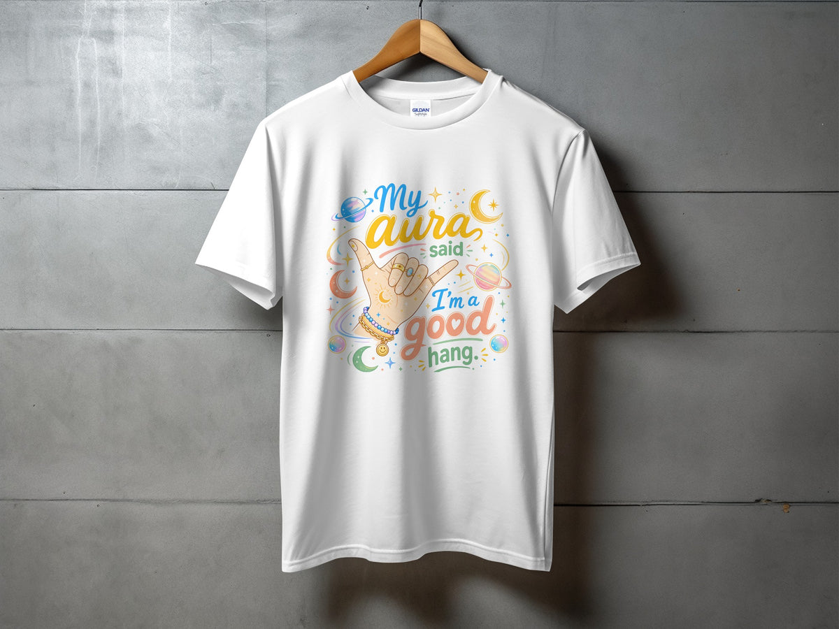 White t-shirt with "My aura said I'm a good hang" graphic and hand gesture.