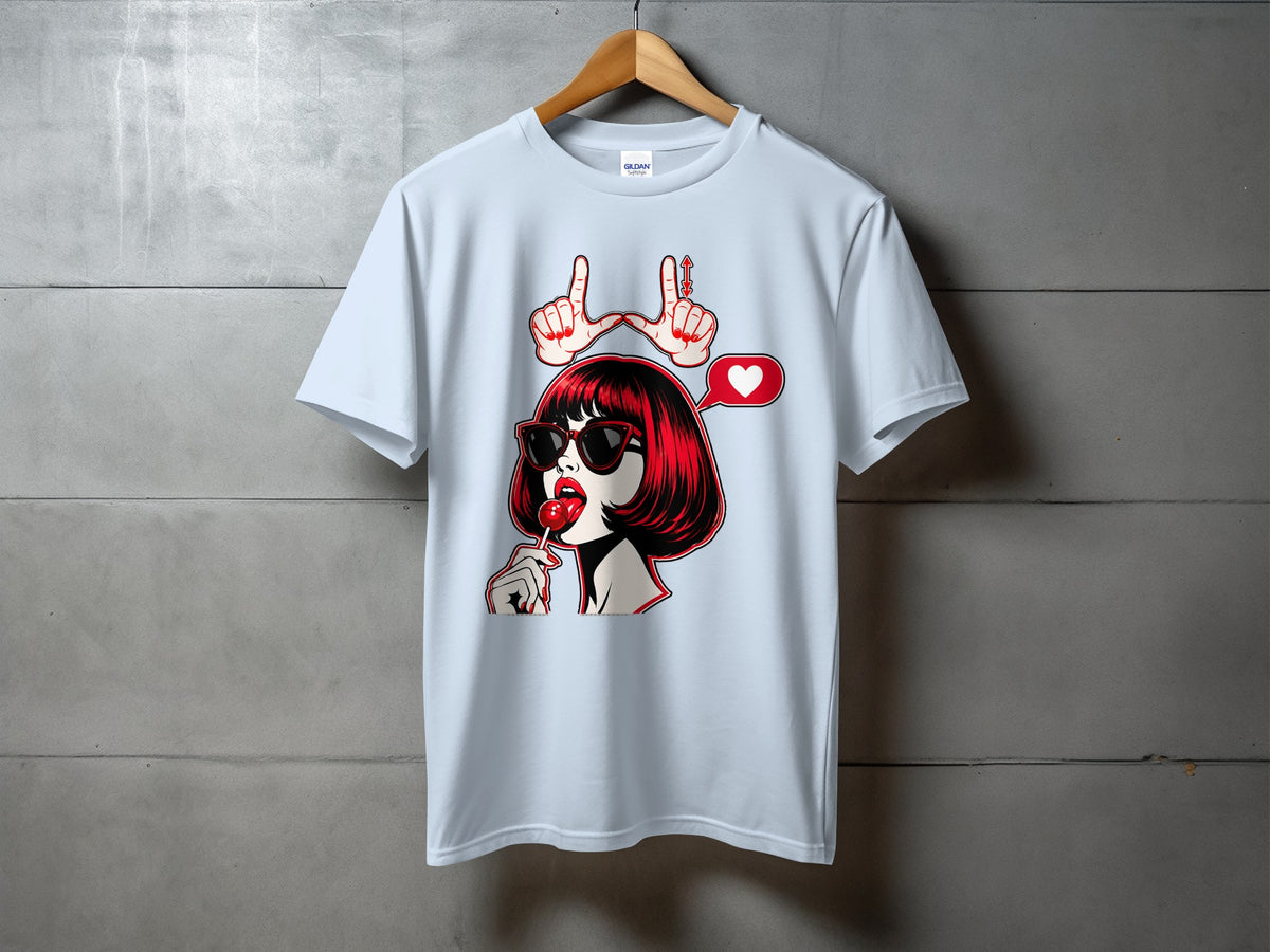 Light blue t-shirt with graphic of woman licking lollipop, heart speech bubble, and hand gesture.