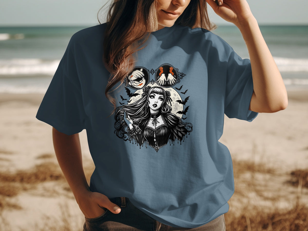 Gothic woman with bats and moon design on a blue t-shirt.