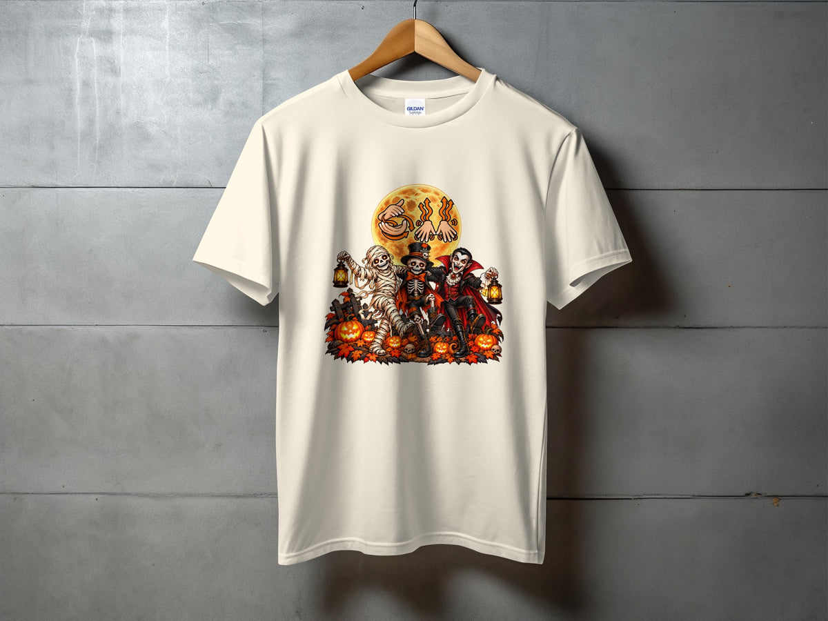 Cream t-shirt with Halloween graphic of mummy, skeleton, and vampire around pumpkins.