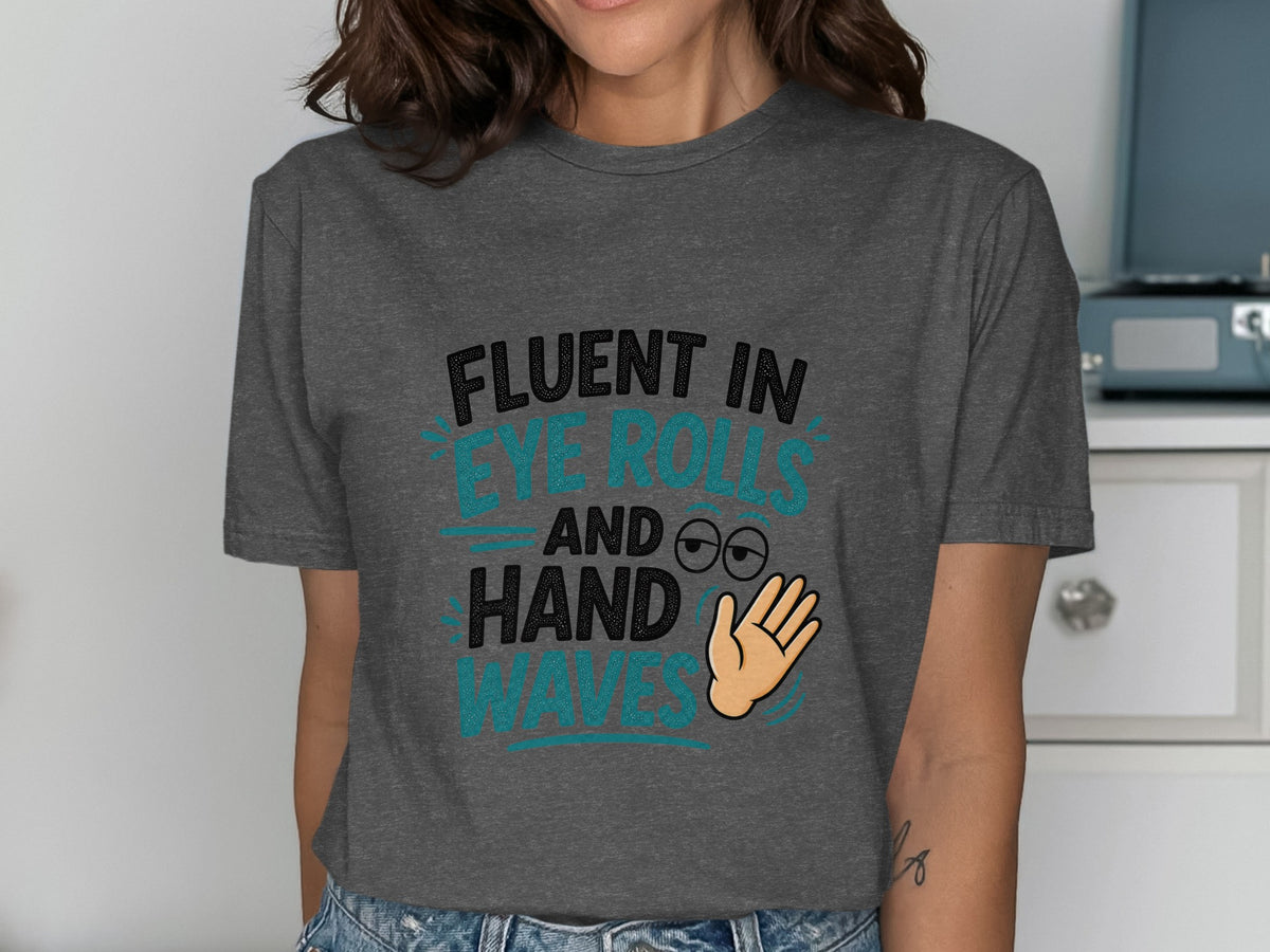 Dark grey t-shirt with text "Fluent in eye rolls and hand waves" and cartoon graphics.