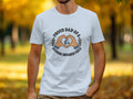 White t-shirt with "Proud Dad of a Hearing Impaired Child" text and heart hands with hearing aid graphic.