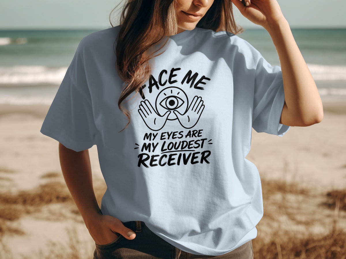 Light blue t-shirt with black text reading "face me my eyes are my loudest receiver."