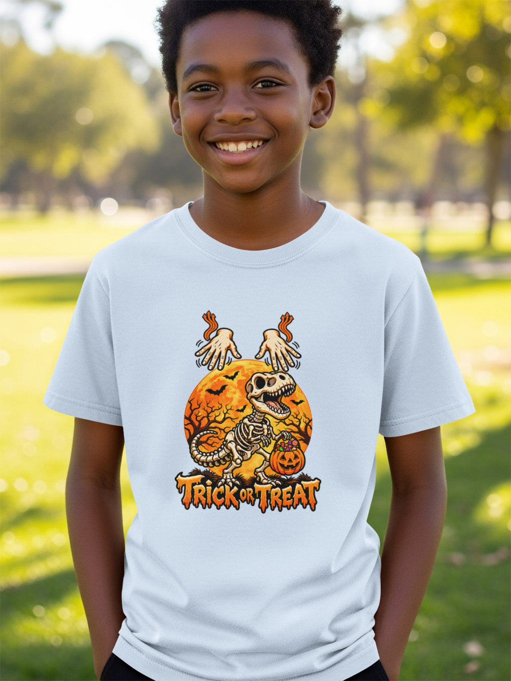 Skeleton dinosaur with pumpkin and text "Trick or Treat" on shirt.