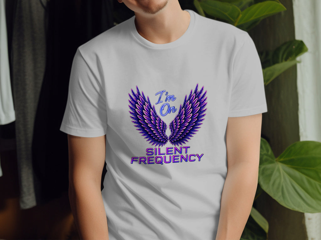 White t-shirt with purple wings graphic and text "I'm On SILENT FREQUENCY".