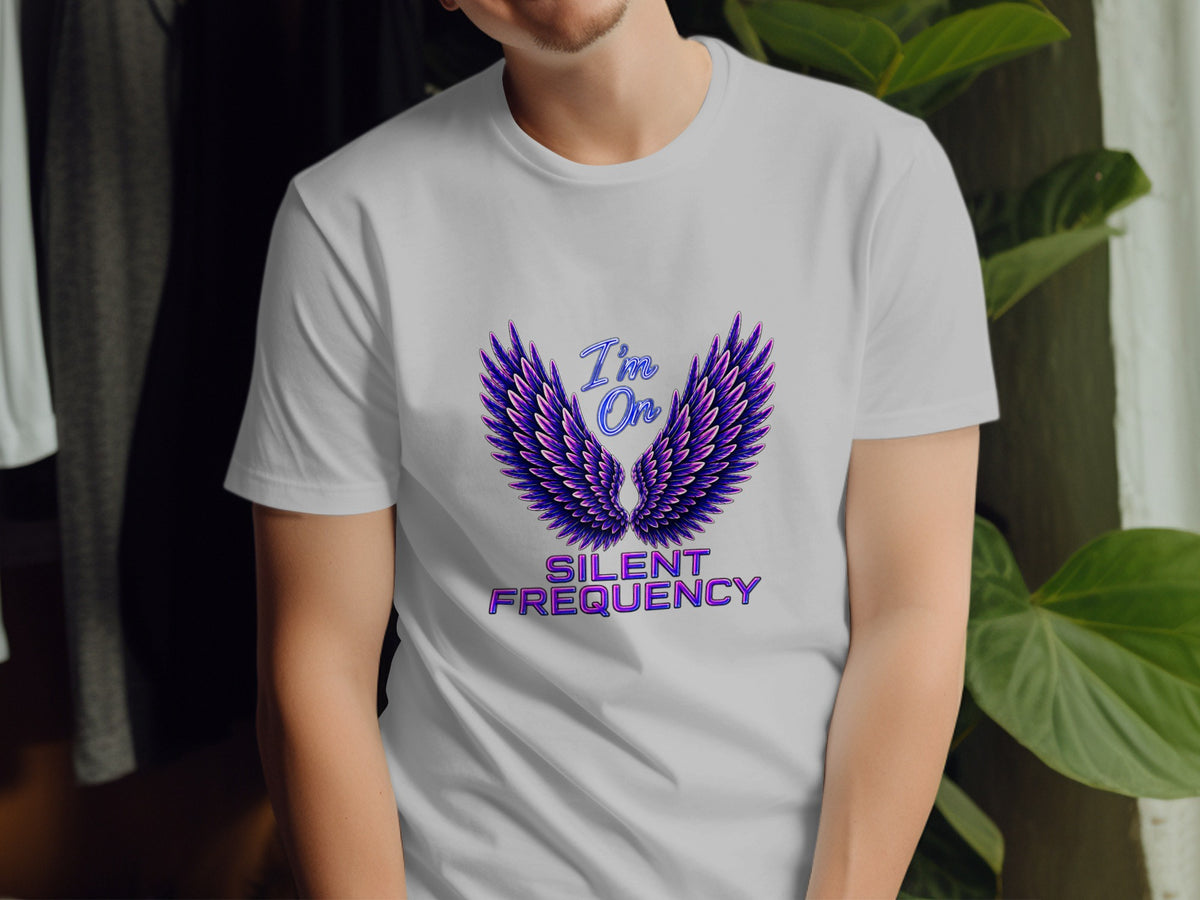 White t-shirt with purple wings graphic and text "I'm On SILENT FREQUENCY".
