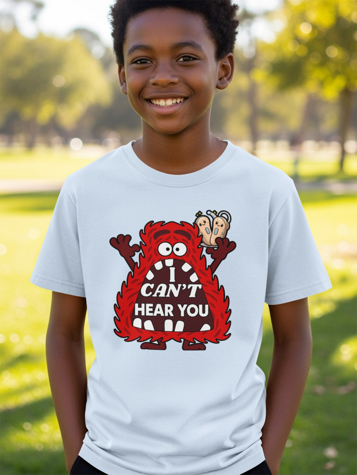 Light blue t-shirt with cartoon monster and text "I CAN'T HEAR YOU".