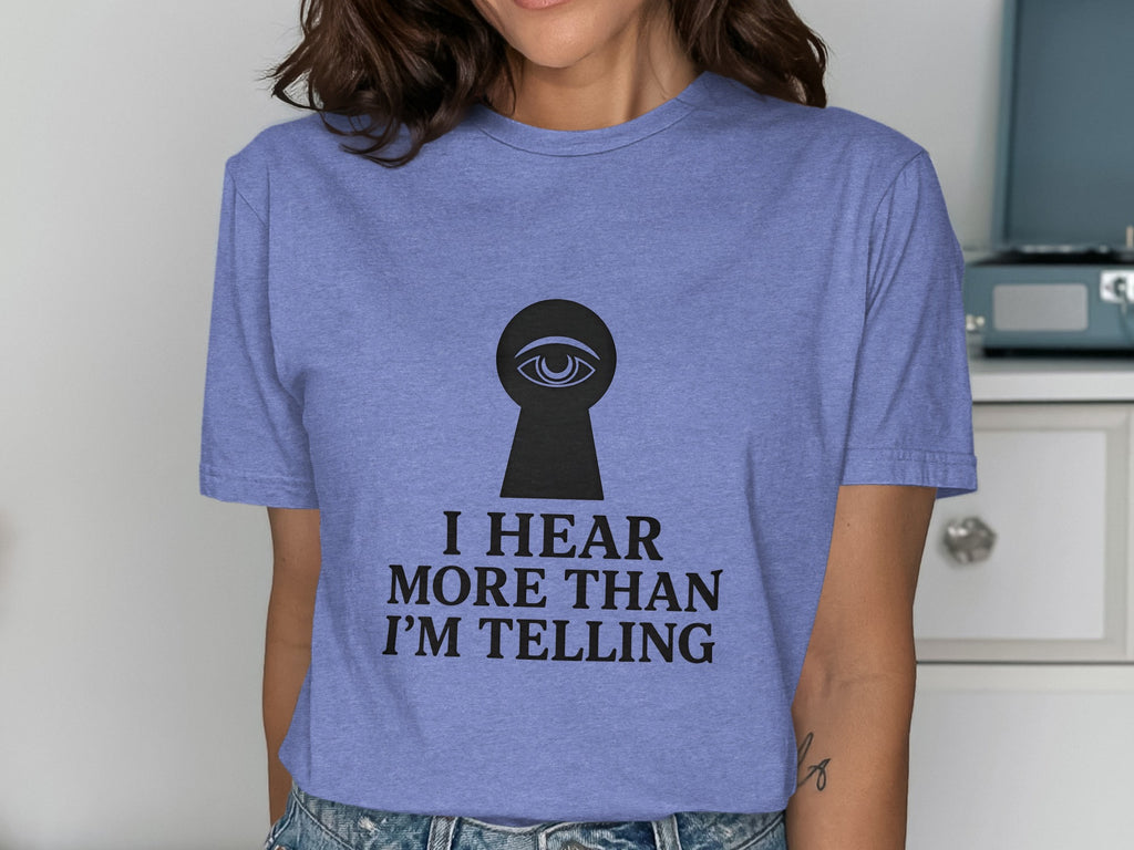 Purple t-shirt with keyhole graphic and "I hear more than I'm telling" text.