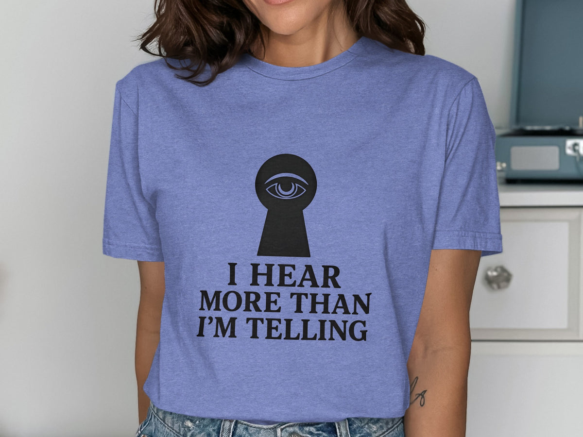 Purple t-shirt with keyhole graphic and "I hear more than I'm telling" text.