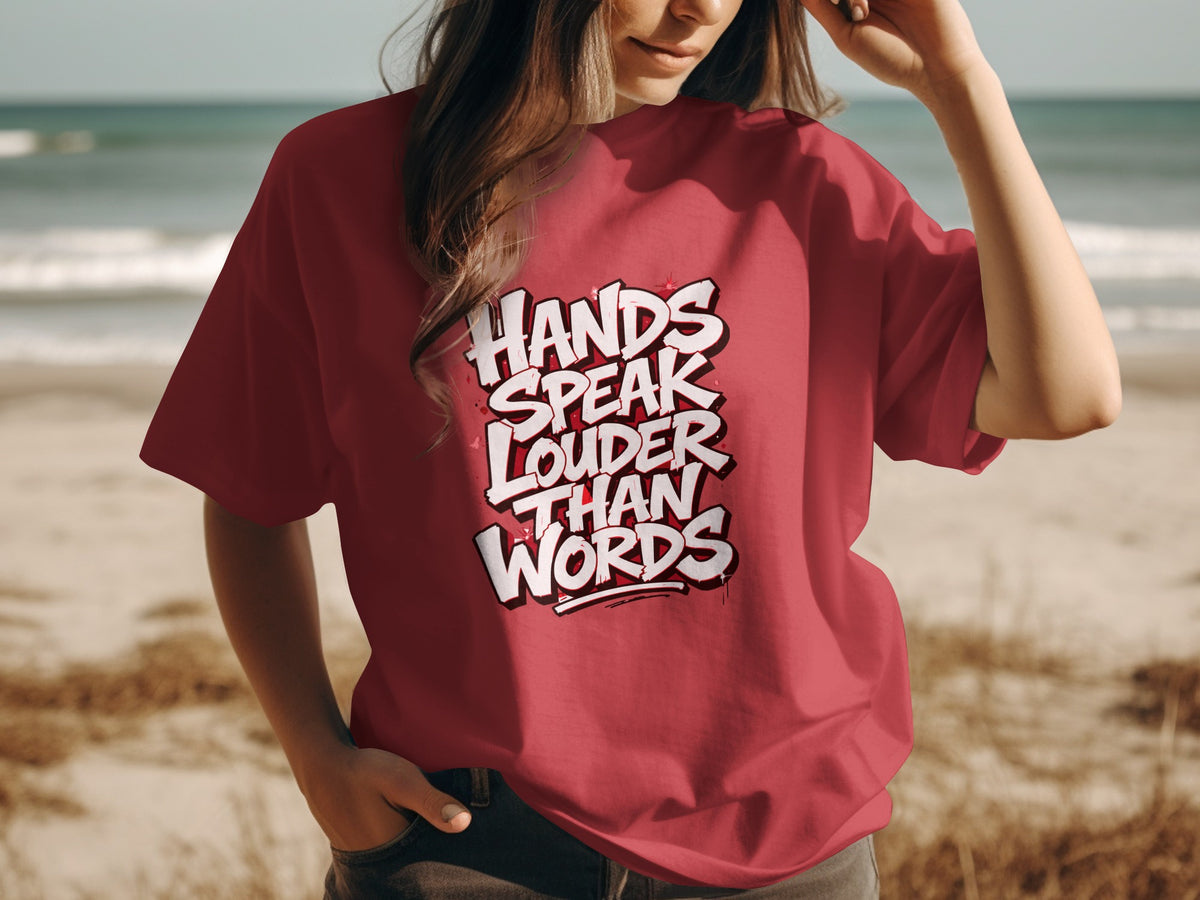 Red t-shirt with white text: "HANDS SPEAK LOUDER THAN WORDS".