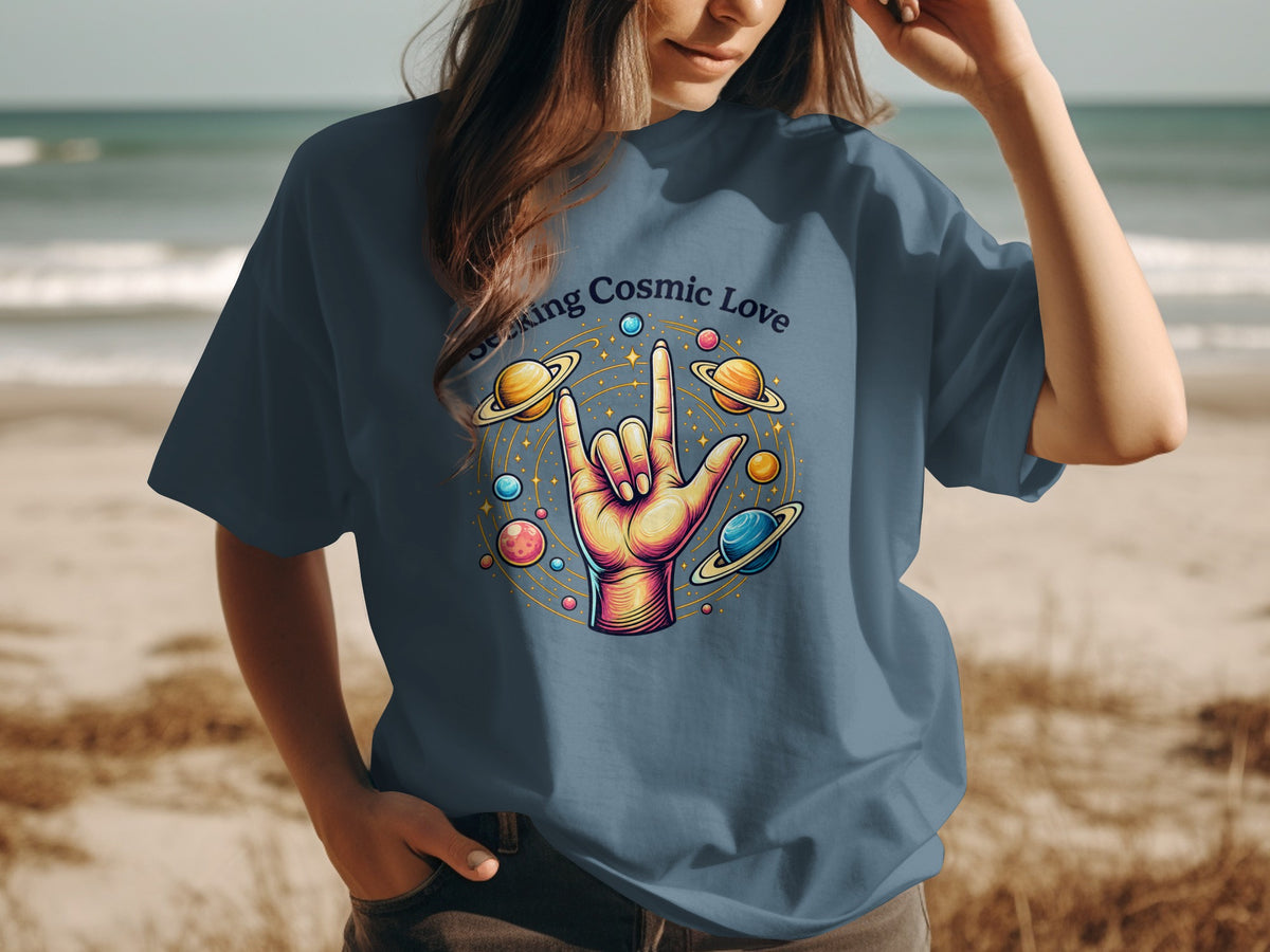 Graphic tee with "Seeking Cosmic Love" text and hand gesture surrounded by planets.