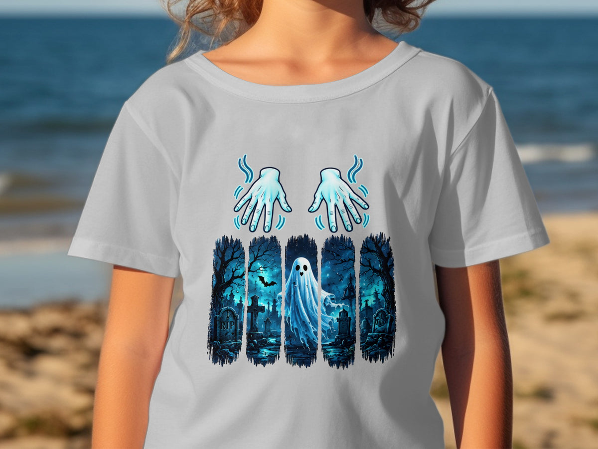 Ghost in a graveyard with glowing hands graphic on a t-shirt.