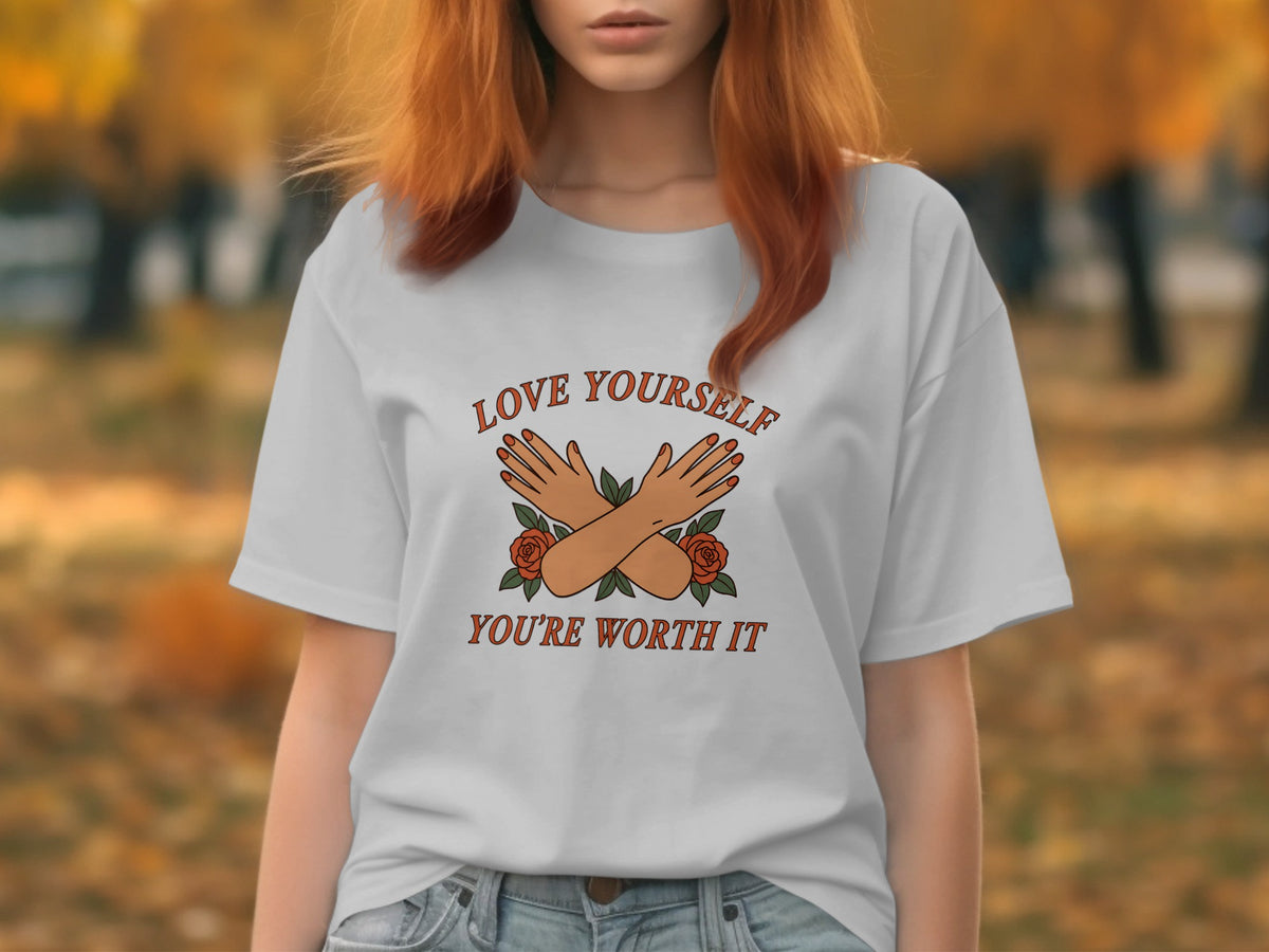 White t-shirt with "LOVE YOURSELF" and "YOU'RE WORTH IT" text, crossed arms, and roses.