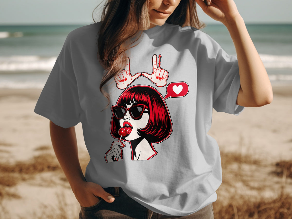 Graphic t-shirt with pop art woman, lollipop, and heart bubble.