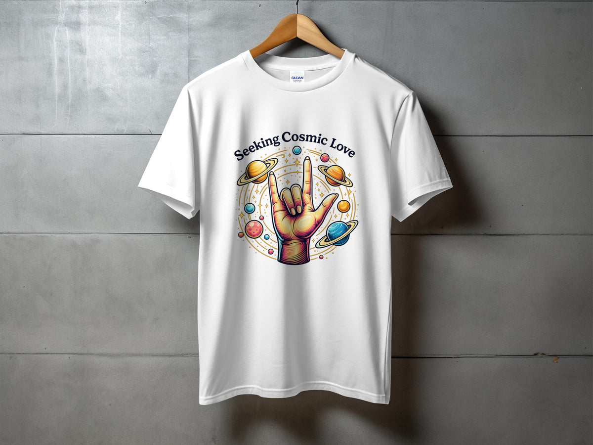 White t-shirt with a colorful graphic of a hand making a rock-on sign surrounded by planets and stars, with text.
