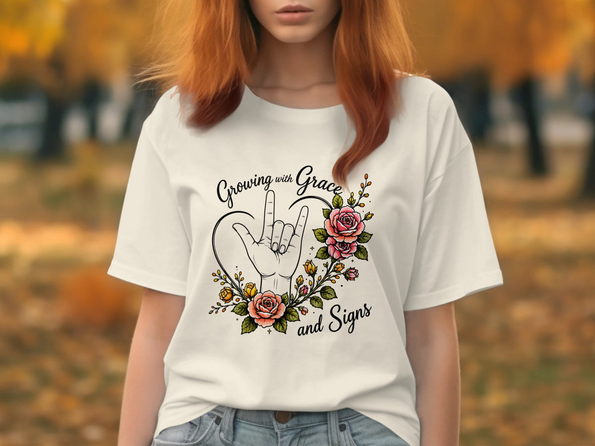 White t-shirt with "Growing with Grace and Signs" and a hand signing "I love you" surrounded by roses.