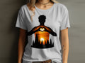 T-shirt with silhouette of person making heart shape over sunset landscape.