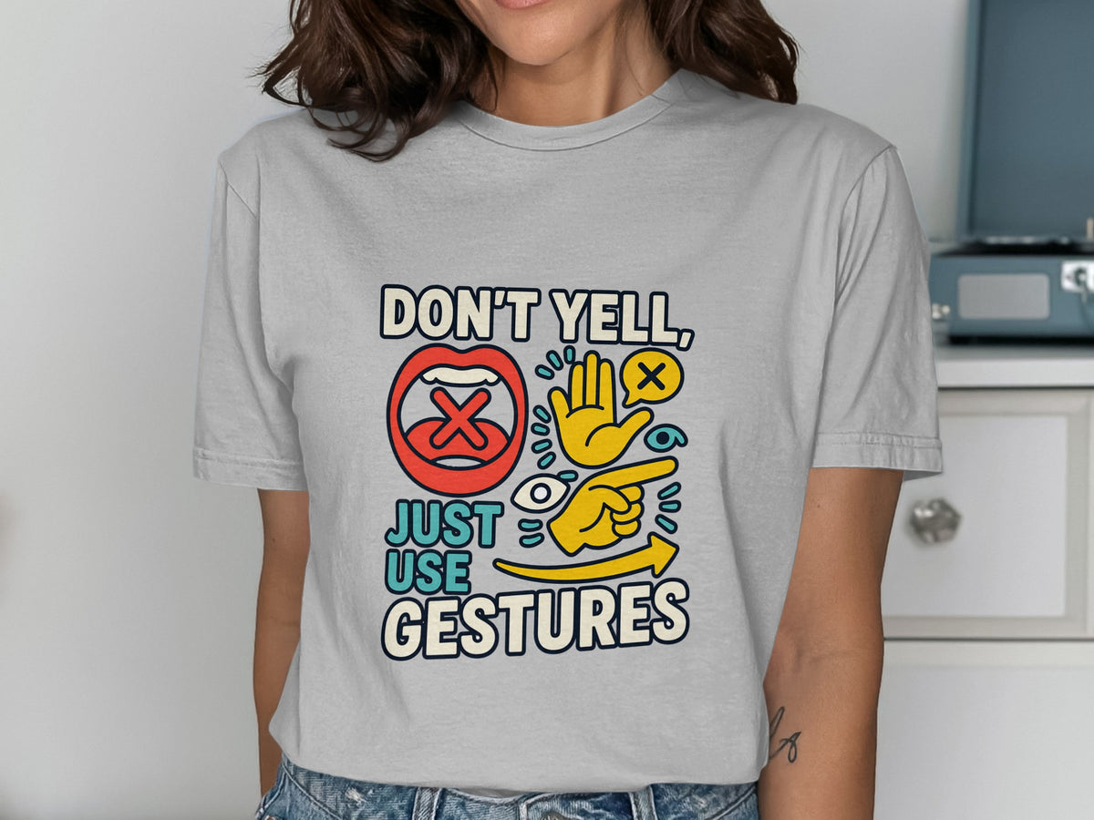 Gray t-shirt with text "DON'T YELL, JUST USE GESTURES" and graphic icons.