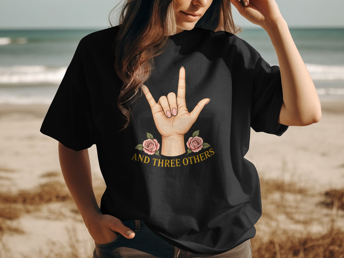 Black t-shirt with ASL sign language "I love you" symbol, roses, and text "and three others."