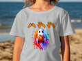 Ghost holding pumpkin with watercolor splashes and ASL alphabet hands above.