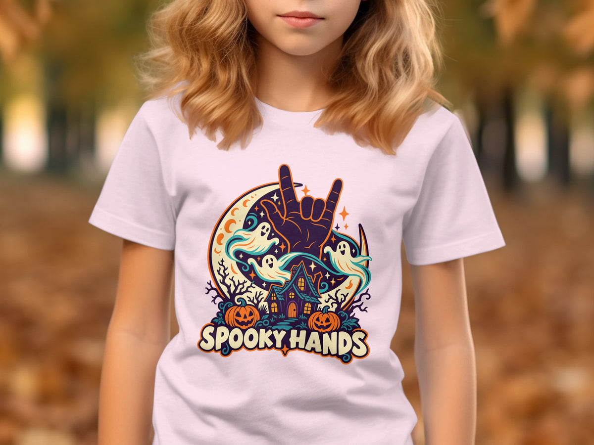 White t-shirt with Halloween graphic: spooky house, ghosts, pumpkins, and text "SPOOKY HANDS".