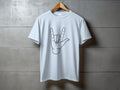 White t-shirt with black outline of rock on hand symbol.
