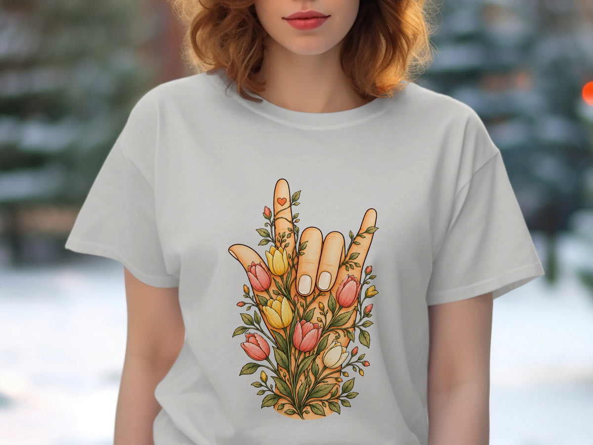 White t-shirt featuring a hand giving the "rock on" gesture surrounded by colorful tulips and greenery.