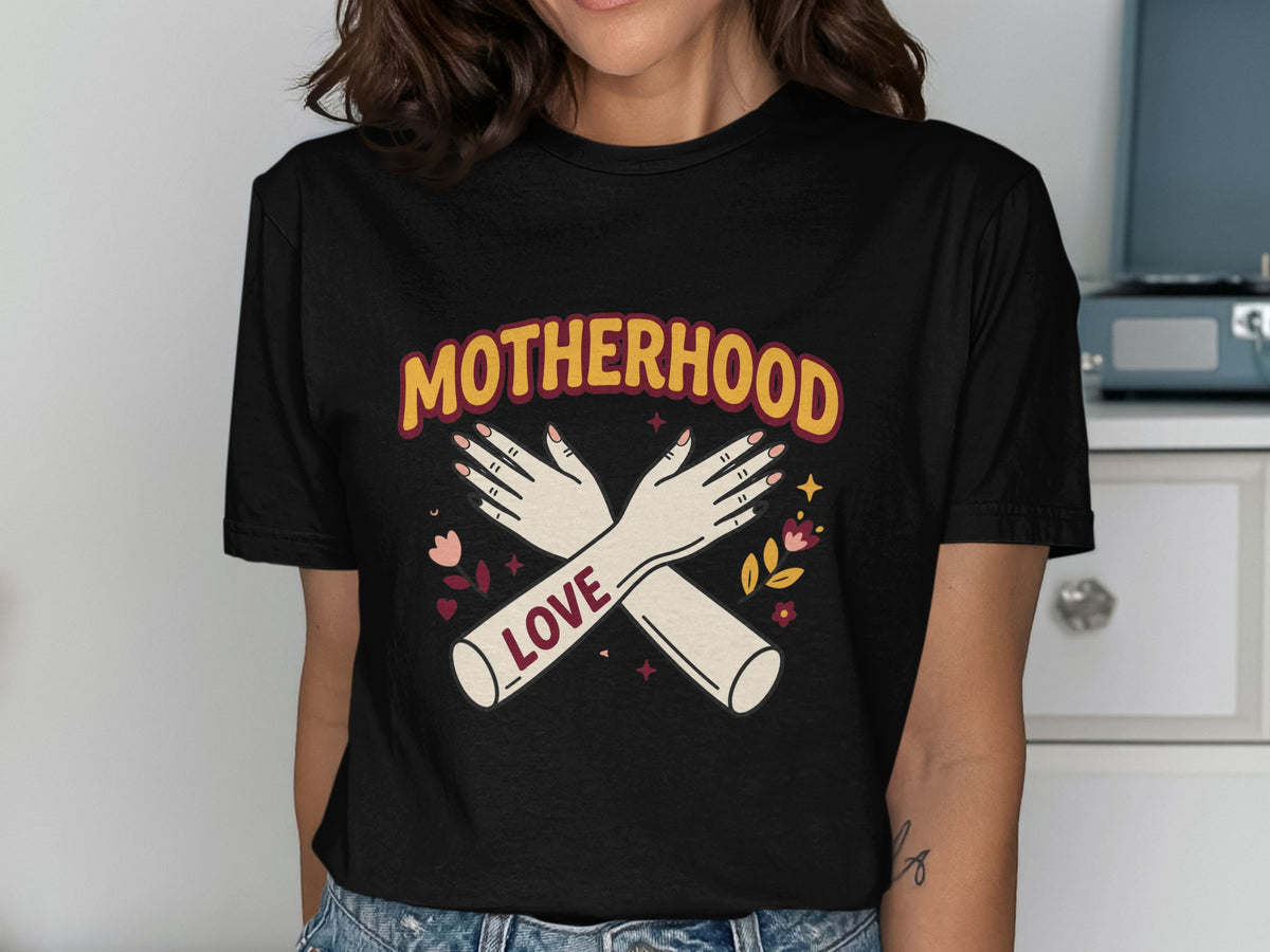 Black t-shirt with "Motherhood" text, crossed arms, and flowers design.