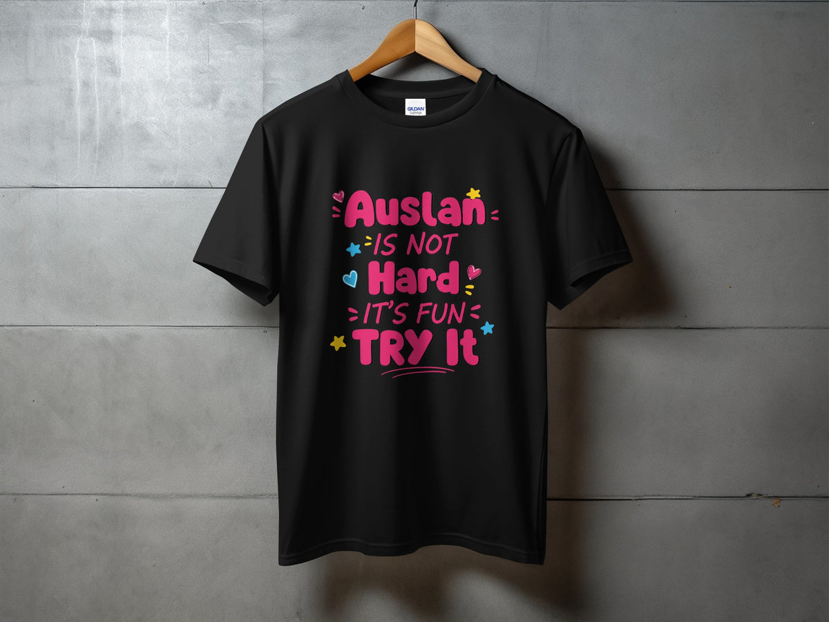 Black t-shirt with pink text that says "Auslan is not hard, it's fun, try it."
